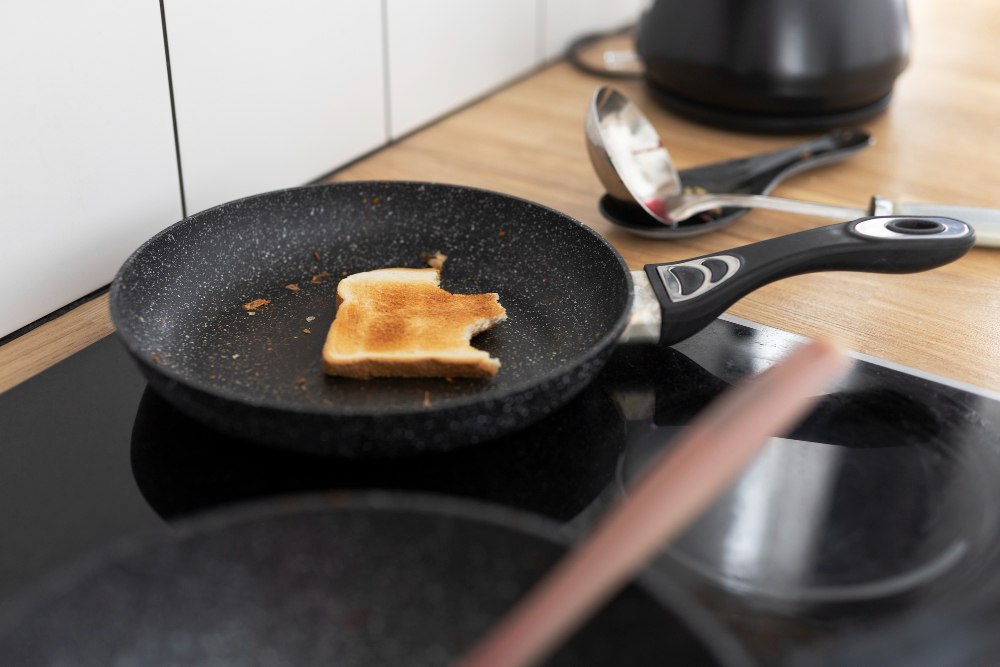 Nowoczesna patelnia z powłoką tytanową i metalową rączką w kuchni domowej